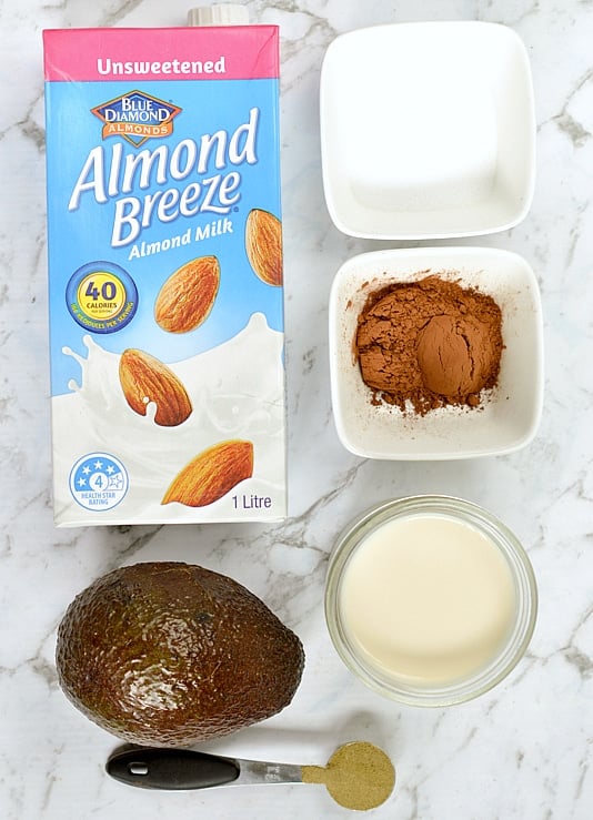 Ingredients for Chocolate avocado smoothie laid on a marbled benchtop.